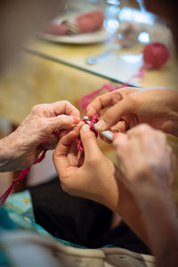 Cropped hand making craft product at table