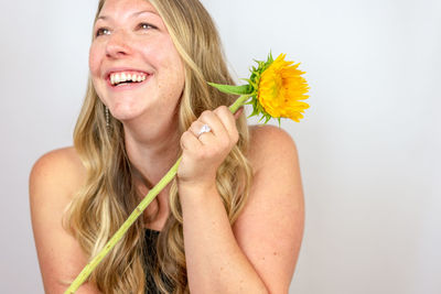 Portrait of a smiling young woman against white background