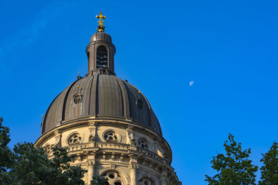 Low angle view of historic building against clear blue sky