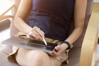 Midsection of woman using laptop