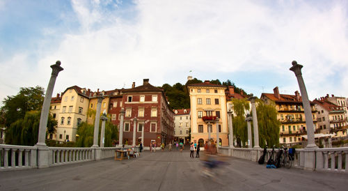 People on street amidst buildings in town