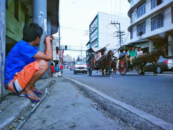 Rear view of man on street in city