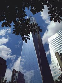 Low angle view of modern building against cloudy sky