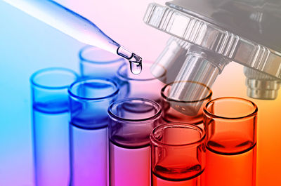 Digital composite image of scientific experiment over multicolored background