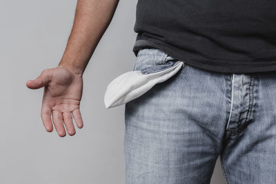 Midsection of man standing against white background