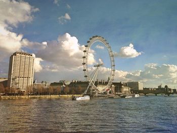 Ferris wheel against cloudy sky