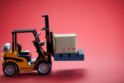 Close-up of toy car against pink background