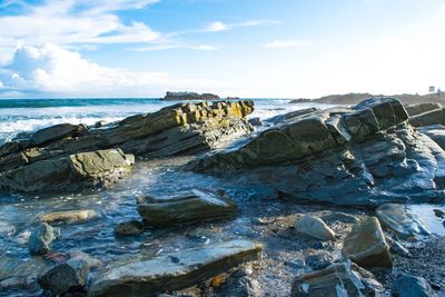 Scenic view of sea against cloudy sky