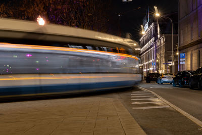 Moscow tram light trails on street in city at night
