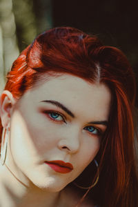 Close-up portrait of beautiful redhead woman with red lipstick