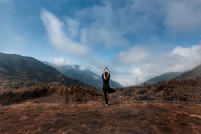 Man standing on mountain against sky