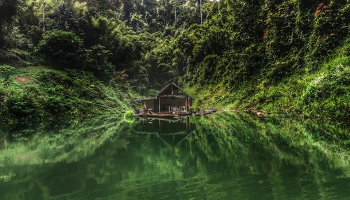 Deserted house floating in a dam jungle