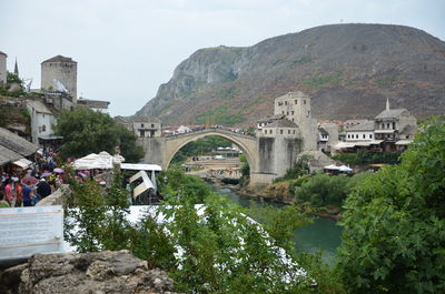 View of arch bridge against cloudy sky