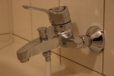 Close-up of faucet in bathroom