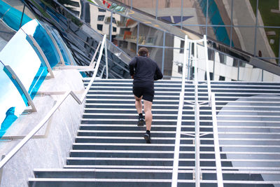 Low angle view of man walking on staircase