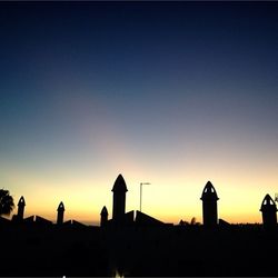 Silhouette built structure at sunset