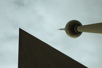 Fernsehturm tower in berlin against a cloudy sky