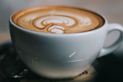 Close-up of cappuccino served on table