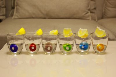 Drinks with lemons in glasses arranged on table