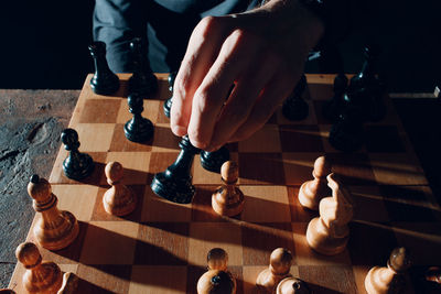 High angle view of men playing on chess board