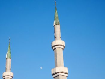 Low angle view of bell tower against blue sky