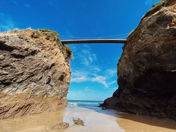 Scenic view of bay and islands with bridge between against clear blue sky