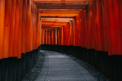 Empty footpath amidst torii gate at fushimi inari shrine