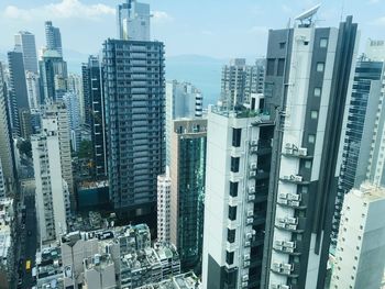 Aerial view of buildings in city against sky