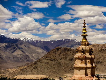 View of tibetan buddhist temple against cloudy sky