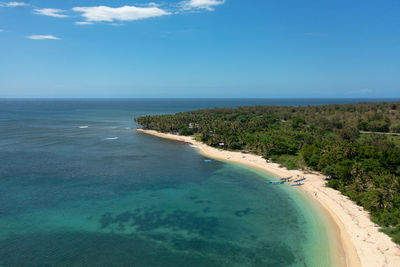 Beautiful sandy beach with palm trees and sea surf with waves. pagudpud, ilocos norte philippines