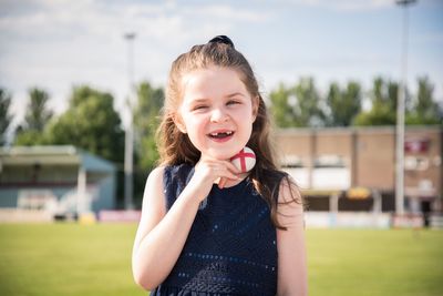Portrait of smiling girl on football field