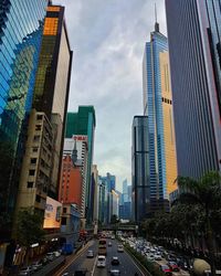 View of city street and buildings against sky