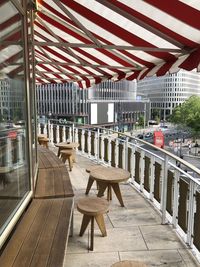 Empty chairs and tables in restaurant against building