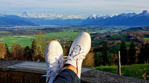 Low section of feets in front ofview point to mountains