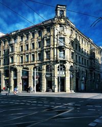 Road by building against sky