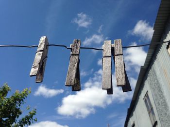Low angle view of clothesline against sky