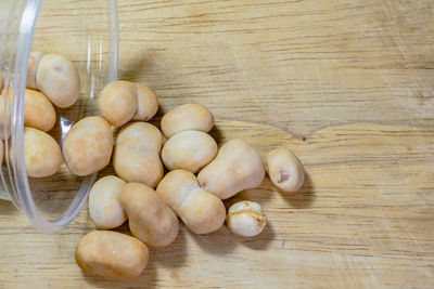 Close-up of beans spilling from container on table