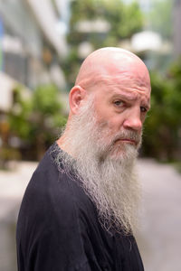 Close-up portrait of man looking away outdoors