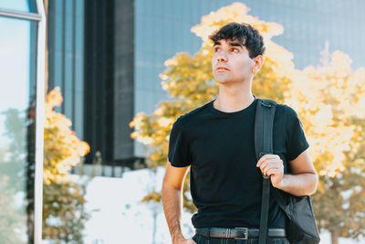 Young man standing in city
