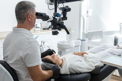 Rear view of man working at clinic