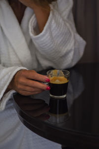 Midsection of woman holding coffee