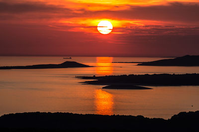 Scenic view of sea against romantic sky at sunset