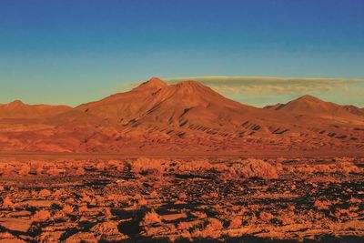 Scenic view of mountains against clear blue sky