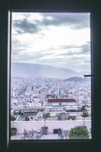 Cityscape against sky seen through window