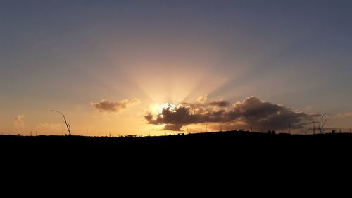 Silhouette landscape against sky during sunset