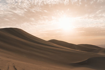 Scenic view of desert against sky during sunset