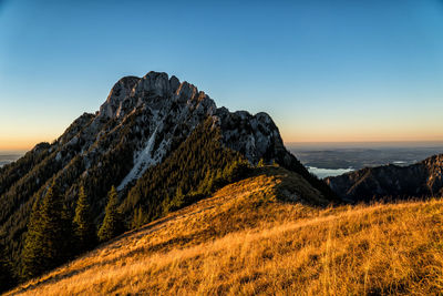 Scenic view of mountains against clear sky during sunset