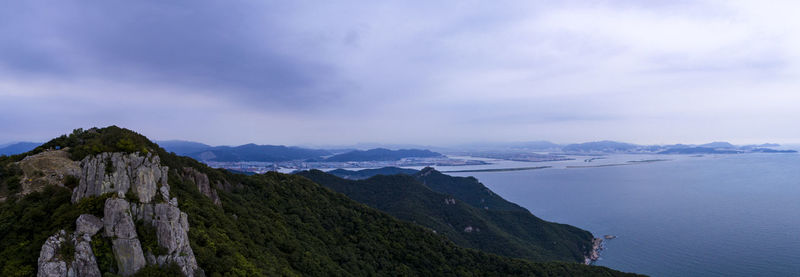 Panoramic view of sea and mountains against sky