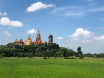 Panoramic view of temple on field against sky