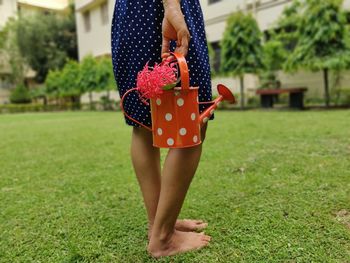 Midsection of woman standing on field